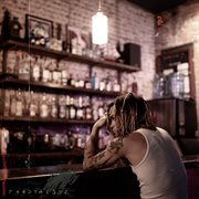 Alone in a dive bar cover image